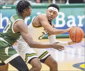  ?? James Franco / Special to the Times Union ?? Siena junior Jalen Pickett looks to pass while defended by Manhattan junior Elijah Buchanan on Friday. Pickett had 12 points and five assists.