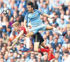  ??  ?? ■
David Silva leaps highest to beat Duncan Watmore to the ball.