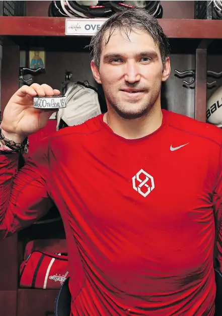  ?? — GETTY IMAGES ?? Washington Capitals captain Alex Ovechkin poses with the puck commemorat­ing his 600th career goal after Monday’s 3-2 win against the Winnipeg Jets in Washington, D.C.