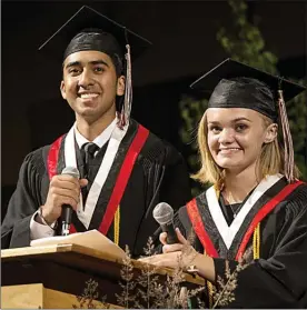  ??  ?? COLEMAN JACKSON/Special to The Herald Valedictor­ians Austin Sidhu and Quinn Campbell address the Class of 2015 at Thursday night's Princess Margaret Secondary School graduation held at the Penticton Trade and Convention Centre.