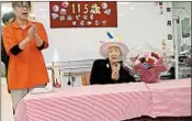 ?? AP ?? Kane Tanaka, right, celebrates her 115th birthday at her nursing home in Fukuoka, southweste­rn Japan.