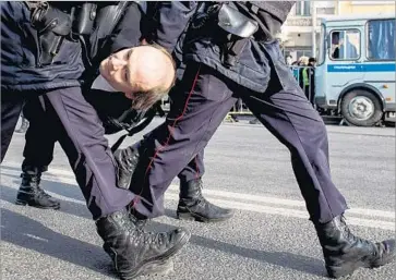  ?? Alexander Utkin AFP/Getty Images ?? A MAN is taken away from an anti-corruption rally in Moscow. Protests come three weeks after an opposition leader released a documentar­y that accuses the prime minister of involvemen­t in massive fraud schemes.