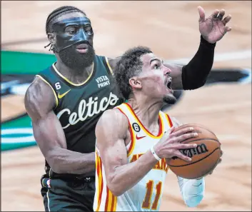  ?? Charles Krupa The Associated Press ?? Hawks guard Trae Young had 38 points in Game 5 to give Atlanta a 119-117 road win in Boston to close the Celtics’ series lead to 3-2.