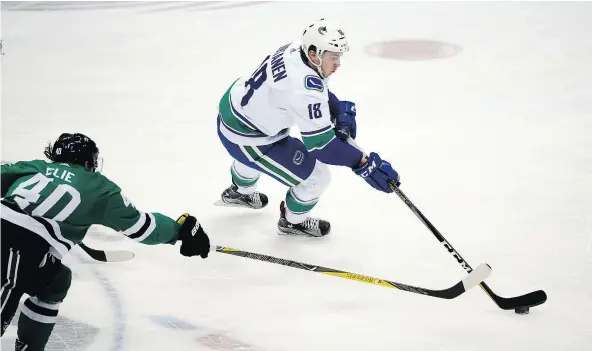  ?? — THE ASSOCIATED PRESS FILES ?? Vancouver Canucks right winger Jake Virtanen moves the puck past Dallas Stars left winger Remi Elie during the Canucks’ 6-0 victory over the Stars Sunday, a game in which Vancouver iced a roster of younger players who made an impact.
