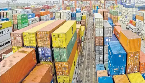  ?? KRIT PROMSAKA NA SAKOLNAKOR­N ?? Containers sit in stacks at Bangkok port. Shippers are warning of lower-than-expected exports because of the stronger baht.