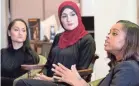  ?? AP ?? Tamika Mallory, right, co-chair of the Women's March on Washington, talks with fellow co-chairs Carmen Perez, left, and Linda Sarsour in 2017.