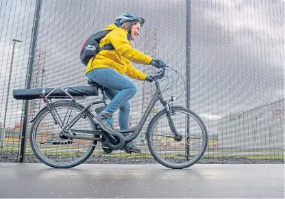  ?? Picture: Kim Cessford. ?? A cyclist riding an e-bike on the newly opened cycle path which runs along the Port of Dundee .