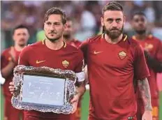  ?? Rex Features ?? Francesco Totti gets an emotional farewell after 24 years with Roma, which ended in a 3-2 win over Genoa in May.