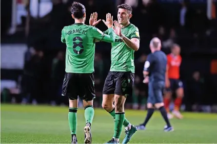  ?? ?? BACK ON TRACK: Danny Batth and Mario vrancic celebrate Stoke’s win after the final whistle against luton Town.