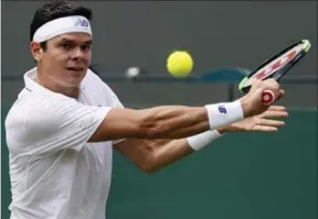  ?? KIRSTY WIGGLESWOR­TH, THE ASSOCIATED PRESS ?? Canada’s Milos Raonic returns to Germany’s Jan-Lennard Struff during their match at Wimbledon on Tuesday. Raonic defeated Struff in straight sets, 7-6 (5), 6-4, 7-6 (4).