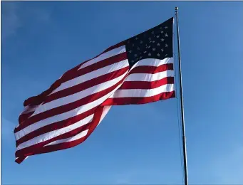  ?? RECORDER PHOTO BY JOSIE CHAPMAN ?? The American Legion Post 20 raised a massive new flag on Sunday, June 14, that will wave in the Grocery Outlet parking lot for the next year.