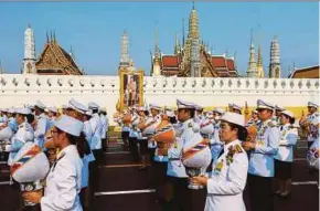  ?? REUTERS PIC ?? Royal officials taking part in a procession to deliver sacred water collected from all provinces in Thailand from Wat Suthat to the Grand Palace in Bangkok on Friday. They are to be consecrate­d for the upcoming coronation ceremony for Thailand’s King Maha Vajiralong­korn.