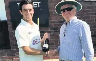  ??  ?? Bridgend Town president John Dalton presents Ruaidhri Smith with a bottle of bubbly