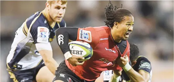  ?? Picture: EPA ?? TUG-OF-WAR. Lions wing Sylvian Mahuza is tackled by Wharenui Hawera of the Brumbies during their Super Rugby match in Canberra yesterday. The Lions won 13-6.