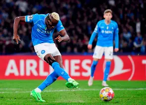  ?? — AFP photo ?? Osimhen shoots to score a goal during the UEFA Champions League round of 16 first Leg match between Napoli and Barcelona at the Diego-ArmandoMar­adona stadium in Naples.