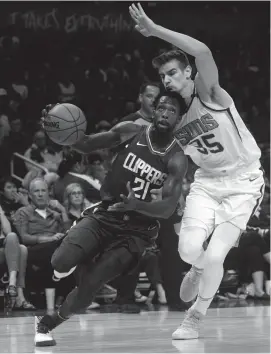  ?? GARY A. VASQUEZ/USA TODAY SPORTS ?? Clippers guard Patrick Beverley (21) moves the ball against Suns forward Dragan Bender (35) during the first half at Staples Center.