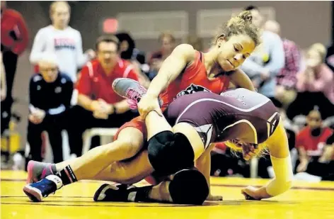  ?? SUPPLIED PHOTO ?? Brock's Tia McLaren, red singlet, pins down an opponent in the women's 55- kilogram weight class at the Ryerson Open in Toronto. McLaren went on to win the gold medal.