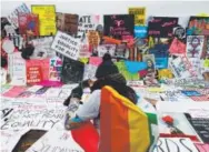  ?? John Minchillo, The Associated Press ?? Protesters build a wall of signs near the White House on Jan. 21, the day of the Women’s March.