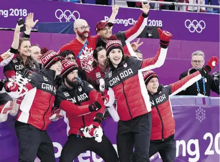  ?? PAUL CHIASSON/THE CANADIAN PRESS ?? From left, Charle Cournoyer, Charles Hamelin, Samuel Girard and Pascal Dion celebrate their bronze-medal finish in the men’s 5,000-metre short-track speedskati­ng relay final.