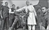  ?? PTI ?? RSS chief Mohan Bhagwat poses for a photo with the 'bull' at BSE in Mumbai on Thursday.