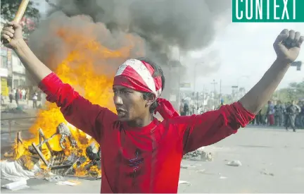  ?? MANAN VATSYAYANA/AFP/GETTY IMAGES ?? A Nepalese pro-democracy protester attends a demonstrat­ion at Kalanki in Kathmandu in 2006. Years of political turbulence have left the Nepali economy in the doldrums and the state woefully unable to cope with a tragedy.