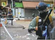  ?? Jerome Favre EPA/Shuttersto­ck ?? POLICE stand guard at the area where a protester was shot by an officer in Sai Wan Ho, Hong Kong.