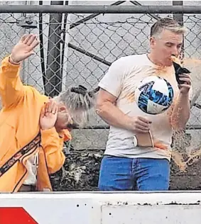  ?? ?? SPILLS Fan’s half-time treat goes flying after the ball hits it at an Elgin City match