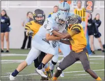  ?? JIM THOMPSON/JOURNAL ?? La Cueva’s Chris Campbell tries to get past Cibola’s Matheus Mitchell (27) and Jordan McClelland during their season-opening game at Community Stadium on Wednesday night.