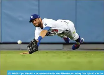  ??  ?? LOS ANGELES: Tyler White #13 of the Houston Astros hits a two RBI double past a diving Chris Taylor #3 of the Los Angeles Dodgers in the sixth inning at Dodger Stadium on August 4, 2018.