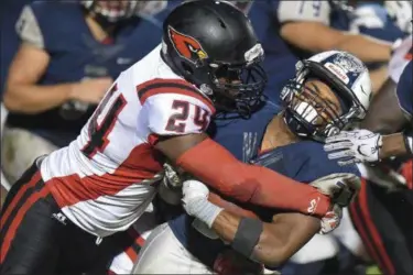  ?? ERIC BONZAR — THE MORNING JOURNAL ?? Lorain running back Carlos Chavis (33) is tackled by Shaw linebacker Tavion Cloud (24).