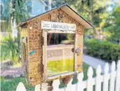  ?? JOY WALLACE DICKINSON ?? A “Little Free Library” in Orlando’s Lake Eola Heights Historic District invites passersby to“take a book/return a book.”