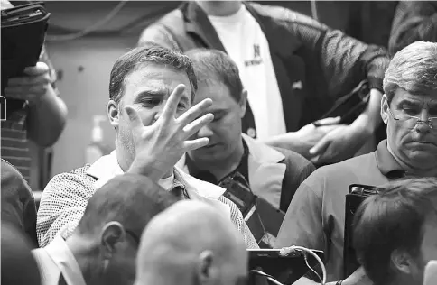  ??  ?? Traders work in the CBOE in Chicago on Thursday, Apr 25, 2013. — WP-Bloomberg photo