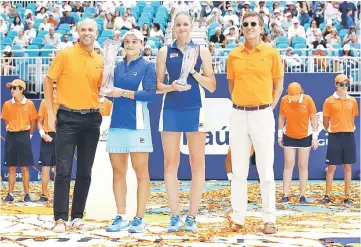  ??  ?? Karolina Pliskova of Czech Republic holds the runners up trophy with winner Ashleigh Barty of Australia next to Tournament Director James Blake (left) during day thirteen of the Miami Open tennis in Miami Gardens, Florida. — AFP photo