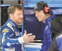  ?? Chuck Burton / Associated Press ?? Dale Earnhardt Jr. (left) talks with crew chief Greg Ives during a practice at Charlotte Motor Speedway in May.