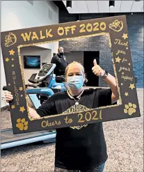  ?? BOB MCPARLAND ?? Cora Umecker, a teacher at Richards High School in Oak Lawn, holds a frame for a photo as Principal Mike Jacobson walks on a treadmill behind her Jan. 1 during a fundraiser for the school scholarshi­p fund.