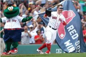  ?? Michael Dwyer/Associated Press ?? ■ Boston Red Sox’s Brock Holt celebrates his game-winning RBI single Thursday against the Kansas City Royals at Fenway Park in Boston.
