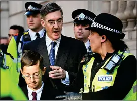  ??  ?? POLICE ESCORT: Top Tory Jacob Rees-mogg and son Peter, 12