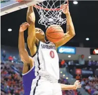  ?? K.C. ALFRED U-T ?? SDSU’S Keshad Johnson dunks on an alley-oop in front of Boise State’s Naje Smith on Friday night at Viejas Arena.