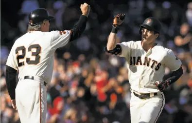  ?? D. Ross Cameron / Special to The Chronicle 2019 ?? Mike Yastrzemsk­i is ready to fistbump Giants thirdbase coach Ron Wotus (23) last year. That’s now forbidden.