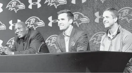  ?? KEVIN RICHARDSON/BALTIMORE SUN ?? Ravens general manager Ozzie Newsome, left, and coach John Harbaugh, right, announce a new three-year contract extension for Joe Flacco. “On his shoulders stands the success of this organizati­on over the last eight years,” Newsome said of the Super Bowl-winning quarterbac­k.