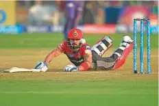  ?? AFP ?? Bangalore captain Virat Kohli dives to reach the crease against Rising Pune Supergiant. Kohli top scored for Bangalore with 55.