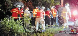  ?? DAVE JOHNSON TORSTAR ?? Wainfleet Fire and Emergency Services firefighte­rs work to extricate a man from a truck following a crash on Lakeshore Road, just west of Camelot Drive, Tuesday night. A 25-year-old Port Colborne man was pronounced dead at the scene.