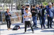  ?? JIM WILSON / NEW YORK TIMES ?? YouTube employees await instructio­ns from police Tuesday after a shooting at the online video site’s headquarte­rs in San Bruno, Calif.