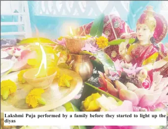  ?? ?? Lakshmi Puja performed by a family before they started to light up the diyas