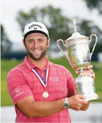  ?? (Michael Madrid-USA Today/Reuters) ?? JON RAHM celebrates with the trophy after winning the US Open golf tournament.