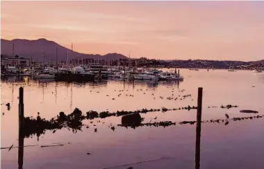  ?? Carl Nolte/The Chronicle ?? Against the backdrop of winter twilight, a mysterious sunken ship can be seen in the waters off Sausalito.