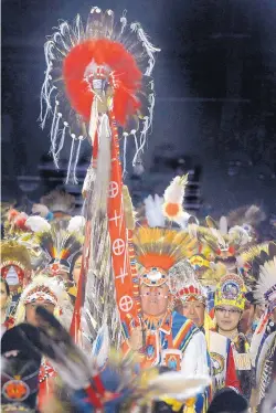  ?? JIM THOMPSON/JOURNAL ?? ABOVE: Terrance Goodwill of Saskatchew­an, Canada, carries the Eagle Staff during the Grand Entry of the 34th annual Gathering of Nations powwow at Expo New Mexico’s Tingley Coliseum.