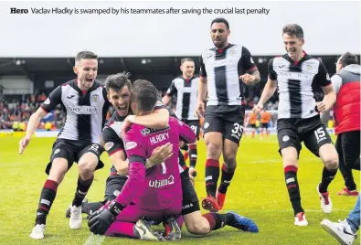  ??  ?? Hero Vaclav Hladky is swamped by his teammates after saving the crucial last penalty