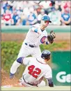  ?? (AP) ?? Chicago Cubs’ Albert Almora Jr (back), throws out Atlanta Braves’ Nick Markakis (front), at the second base during the first inning of a baseball game on May 14, in
Chicago.