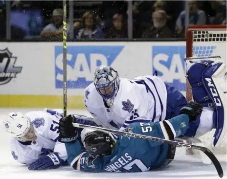  ?? MARCIO JOSE SANCHEZ/THE ASSOCIATED PRESS ?? The Sharks’ Tommy Wingels collides with Leafs goalie Jonathan Bernier and defenceman Jake Gardiner on Saturday in San Jose.